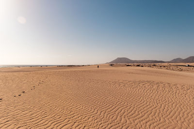 Scenic view of desert against clear blue sky