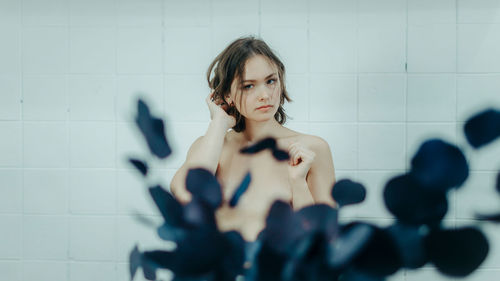 Low angle view of woman standing against wall