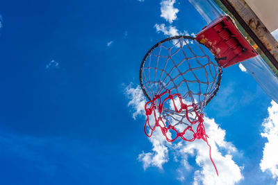 Low angle view of ferris wheel against blue sky