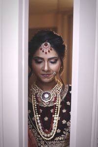 Portrait of beautiful young woman standing at home