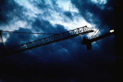 Low angle view of silhouette bridge against sky