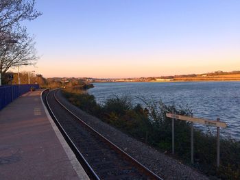 Railroad tracks against clear sky