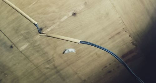 High angle view of cable on hardwood floor