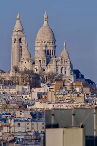 View of buildings in city against sky