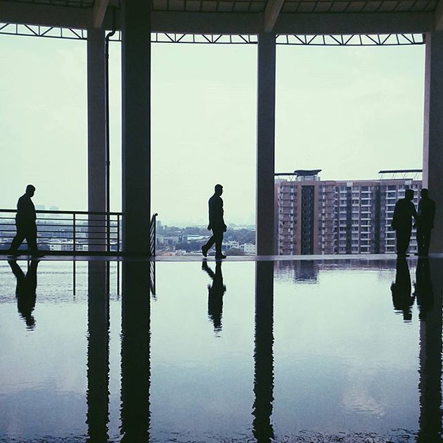 full length, water, reflection, lifestyles, silhouette, built structure, architecture, men, standing, walking, leisure activity, rear view, building exterior, sea, sky, indoors, person