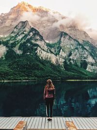 Rear view of woman standing on mountain