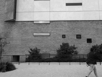 Man photographing with building in background