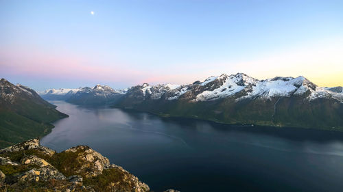 Scenic view of lake and mountains against sky