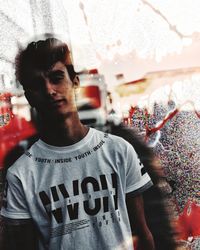 Portrait of young man standing by text