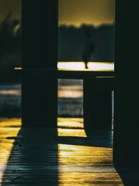 Close-up of glass window against sunset sky