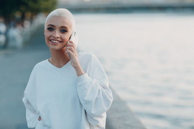 Portrait of a smiling young woman standing outdoors