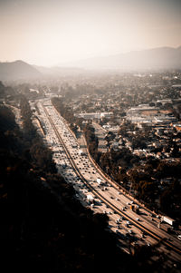 High angle view of road amidst city against sky