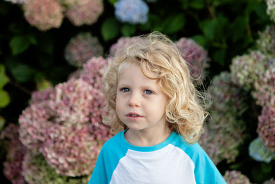 Cute girl against pink flowers