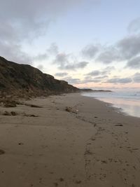 Scenic view of beach against sky during sunset