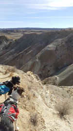 Midsection of man riding motorcycle on mountain against sky