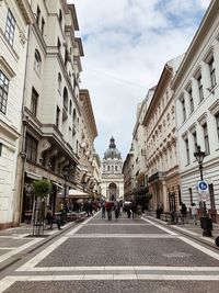 Street amidst buildings in town against sky