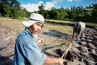 Man wearing hat while standing on field