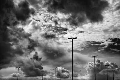 Low angle view of street light against cloudy sky