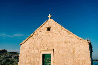 Low angle view of building against clear blue sky