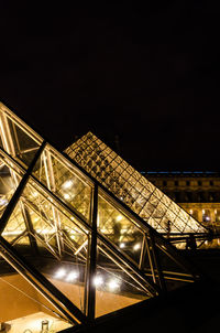 Low angle view of illuminated building against sky at night