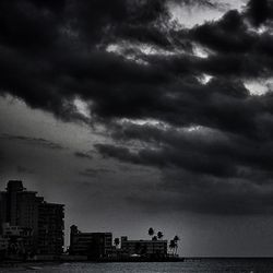 Cityscape against cloudy sky