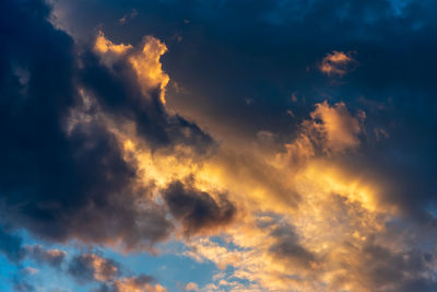 Low angle view of dramatic sky during sunset