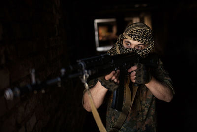 Arab soldier aiming with kalashnikov ak-47 assault rifle.