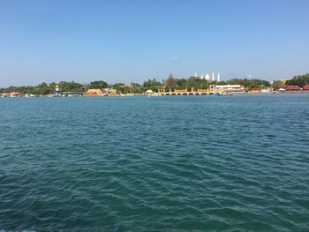 Scenic view of sea against sky in city