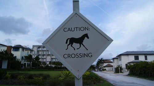 Road sign against sky