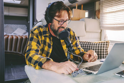 Young woman using laptop while sitting at home