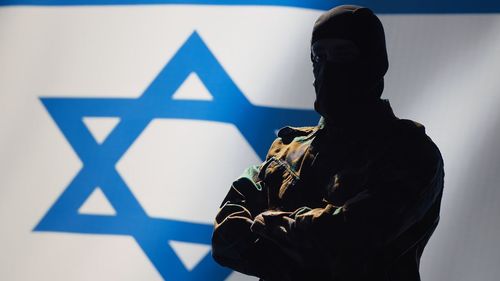 Rear view of man standing against wall