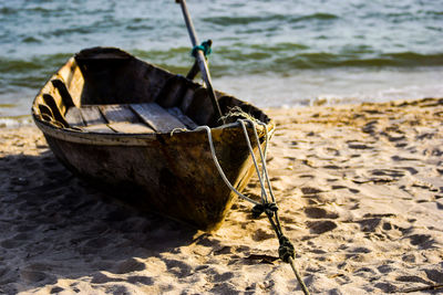 Close-up of boat moored on shore