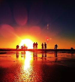 People on beach at sunset