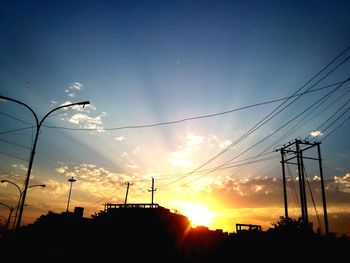 Low angle view of electricity pylon against sky