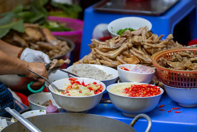 Close-up of hand holding food on table