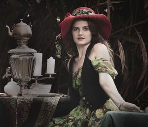 Portrait of young woman sitting outdoors