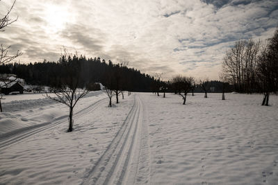 Snow covered field against sky