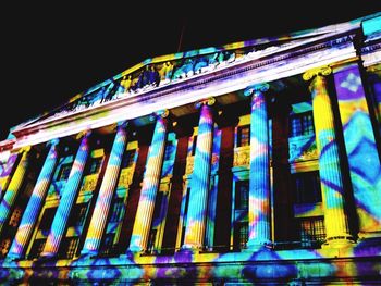 Low angle view of illuminated building against sky at night