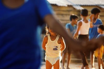 Midsection of girl playing in village