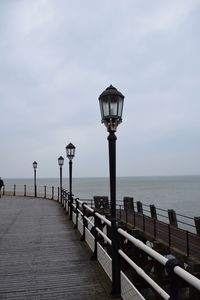 Pier on sea against sky