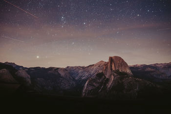 Scenic view of mountains against sky at night