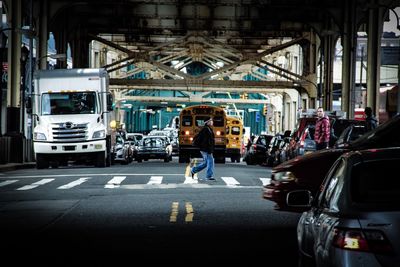 Man standing on road in city