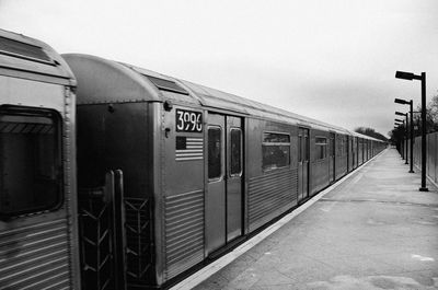 Train at railroad station against clear sky