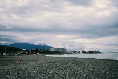 Scenic view of sea by buildings against sky