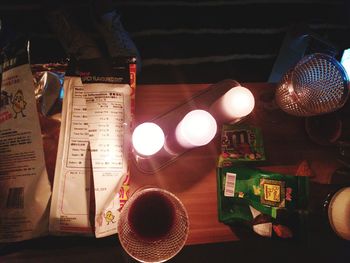 High angle view of illuminated candles on table