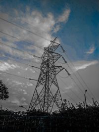 Low angle view of electricity pylon against sky