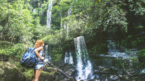 Low angle view of man standing in forest