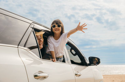 Portrait of smiling young woman in car