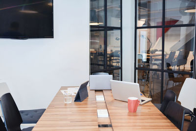 High angle view of laptops on conference table in modern office