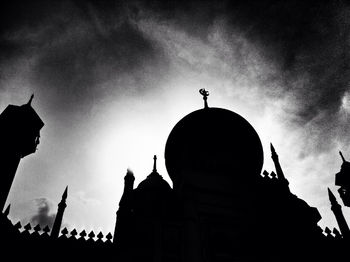 Low angle view of silhouette cathedral against sky